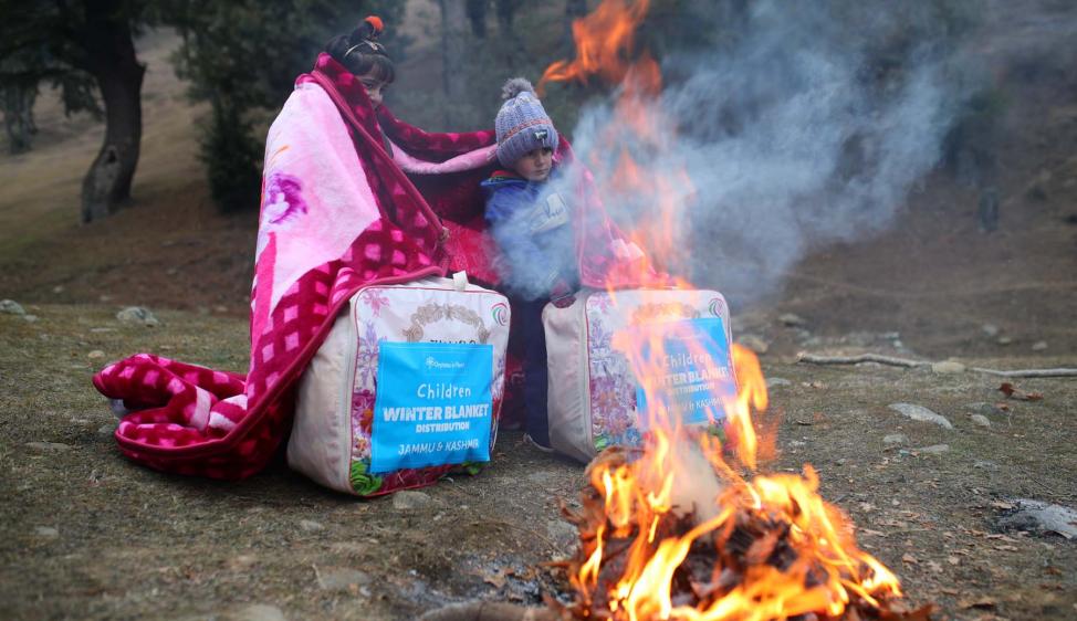 An open fire and winter blanket can be all that&#039;s needed to bring smiles to the faces of children.